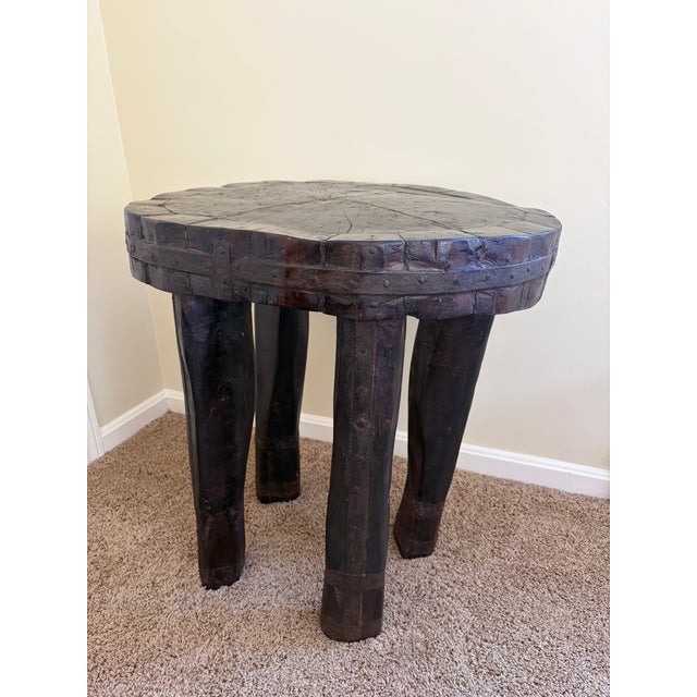 A remarkable antique hand-carved wood and iron side table dating to the early 20th century. Constructed from substantial...