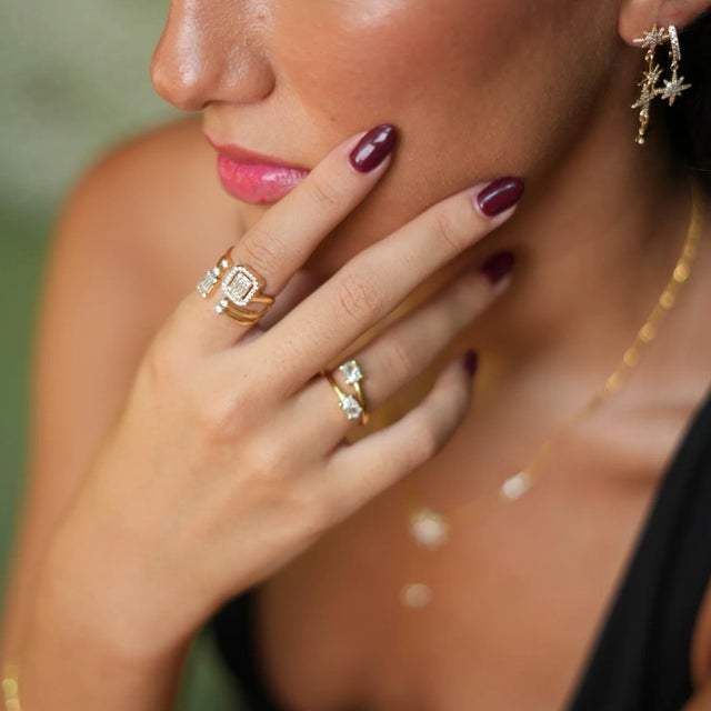 Discover the luxury of our Baguette Diamond Adjustable Gold Fashion Ring, a must-have accessory for fashion-forward women....