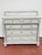 Antique marble-top chest of drawers featuring a beautifully aged painted finish with subtle distressing, fluted column...