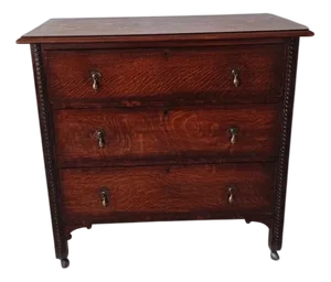 Antique Oak Chest of Drawers on Castors with Brass Handles and Carved Details