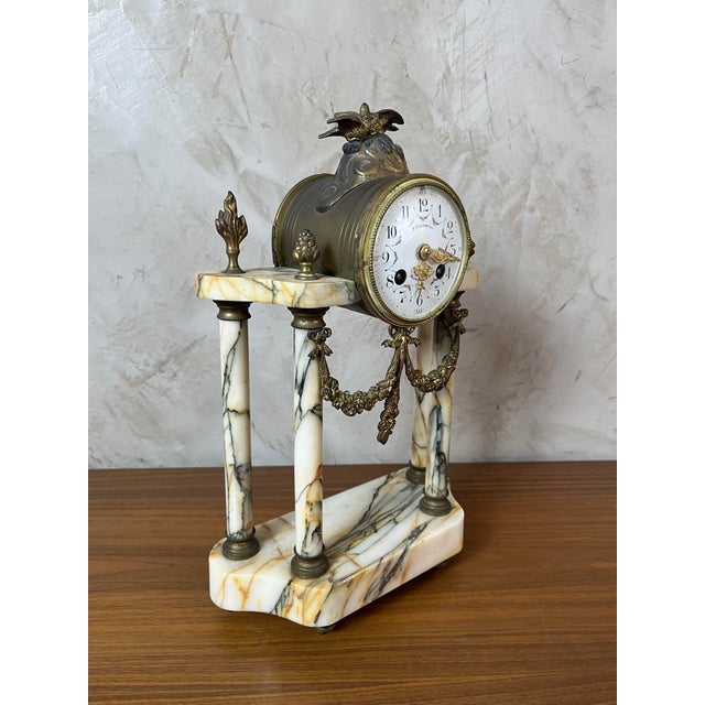 Louis XVI style clock in marble and gilt bronze. Refined details: delicate dial, decorative birds, and floral ornaments....