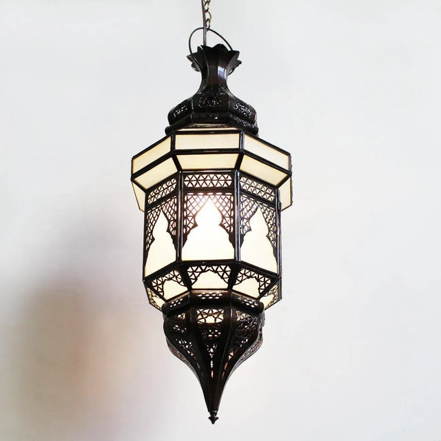 Bronze metal work vintage Moroccan lantern with frosted glass. Intricate hand cut traditional detail. Includes 3' chain...