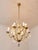 A beautiful chandelier in the subtle rococo style of louis xv. The body of the chandelier is made of polished brass and...