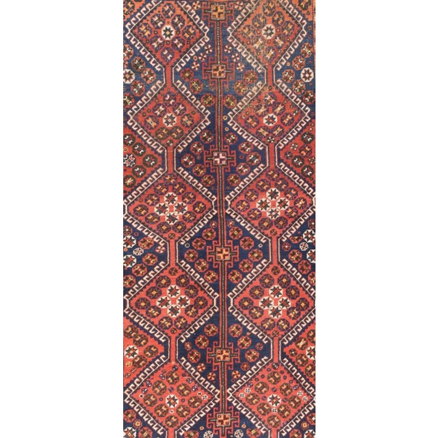 From a neighbouring tribal group to the Qashghai of SW Persia, this all-wool construction long rug shows two columns each...