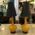 A pair of yellow ceramic lamps with original fitted black shades. The shades show some wear but the lamps are in mint...