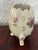 A midcentury porcelain egg-shaped vase from Japan. Stands on three scrolled feet. The cream body is hand painted with...