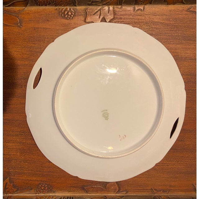 Beautiful round serving plate with built in handles. In V good vintage condition. Slight bit of wear next to one of the...