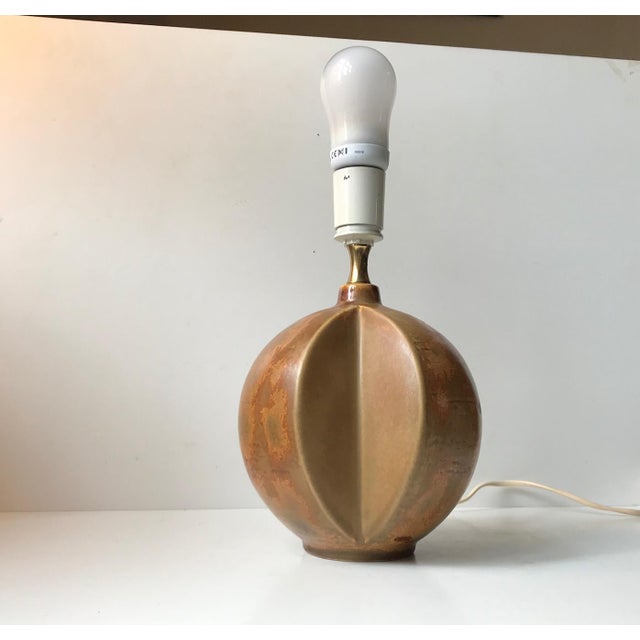 This unique table lamp was designed by ceramist, Heico Nietzsche, and manufactured by Søholm in Denmark. It has a very...