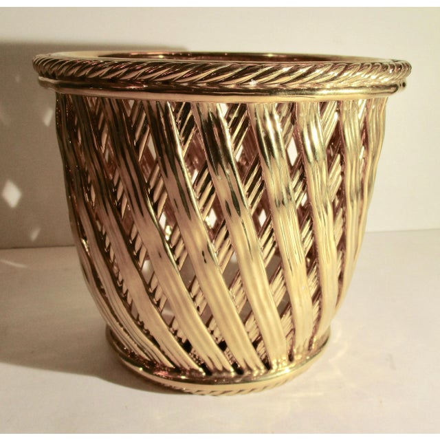 Brightly glazed ceramic golden open weave basket with interior plant saucer for potted plants. Use as cachepot or for...