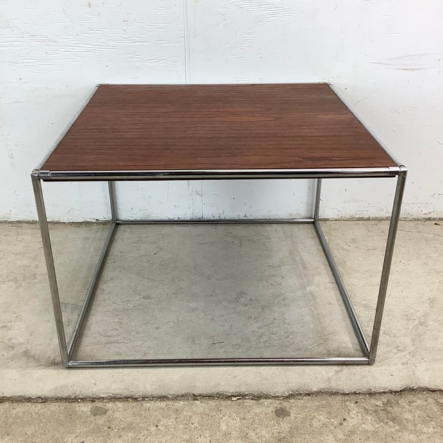 This vintage mid-century modern side table captures the clean geometry and material pairing that defined some of the...