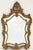 A fine English gilt wall mirror in the Rococo style, featuring a frame with decorative scroll motifs inspired by the...