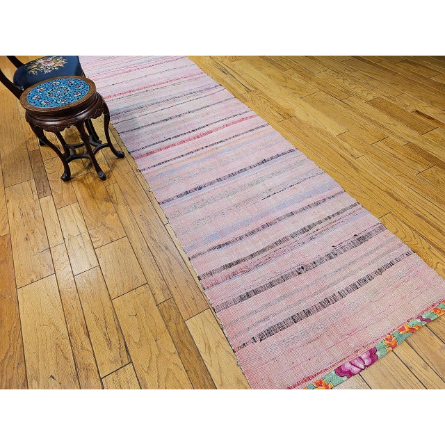 A beautiful and colorful vintage American rag runner of outstanding folk art character, featuring a captivating stripe...