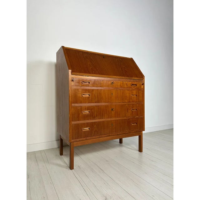 Special vintage secretary original from the 1960s. Danish modern design made of teak wood. Many small details with an...
