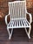 Aluminum Rocking chair of neoclassical inspiration, with curved back slats continuing to form the seat, open arms and...