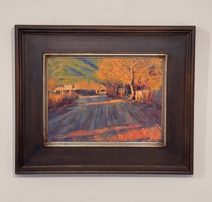 Late Afternoon Taos Pueblo by Lorenzo Chavez | Oil Painting of a sunlit road in Taos Pueblo