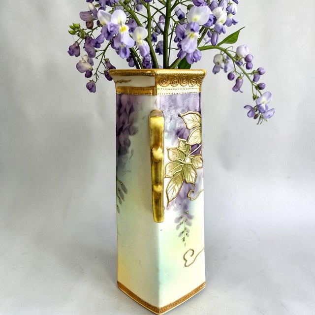 This early 20th century Nippon vase is richly enhanced with intricate raised gold moriage outlining and beaded gilt...