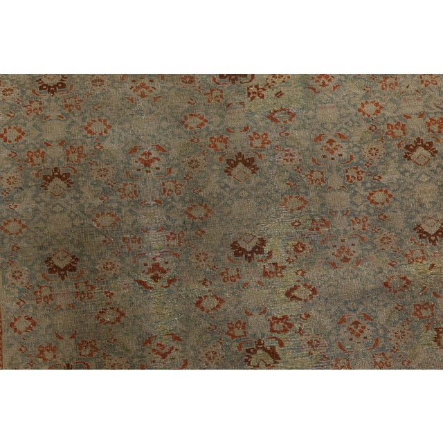 A late 19th century antique Persian Tabriz rug, the pale blue field with an allover pattern of burgundy floral motifs,...