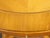 An Austrian Biedermeier period walnut accent table from the 19th century, with oval top, quarter veneer, banding, single...