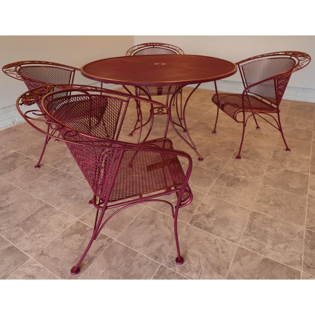 A classic mid-century patio dining set by Russell Woodard, executed in the highly sought-after grapevine pattern, circa...