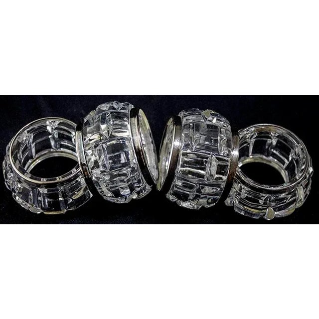Elegant crystal napkin rings surrounded by silverplate borders.