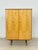 Beautiful, original vintage cabinet from the 1960s, distinguished by its elegant, two-tone design. The fronts gleam in a...