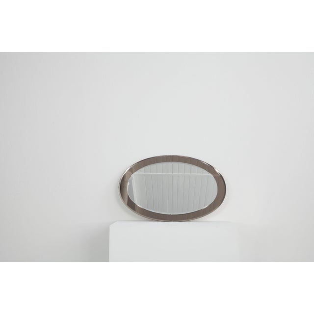This oval, Italian wall mirror dates from the 1960s. The special thing about this mirror is the frame, which is also made...