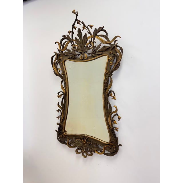 An extraordinary Swedish Art Nouveau mirror, circa 1890, featuring an exuberant arrangement of sculptural foliage, sinuous...