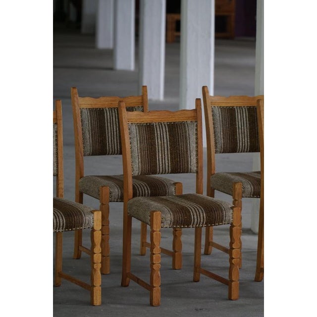 Set of eight dining chairs in the style of Henning Kjærnulf, produced in Denmark during the 1960s. The set containts six...