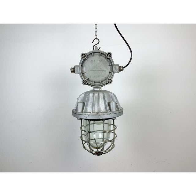 Large industrial factory hanging lamp made by Polam Wilkasy in Poland during the 1970s. It features a cast aluminium body,...