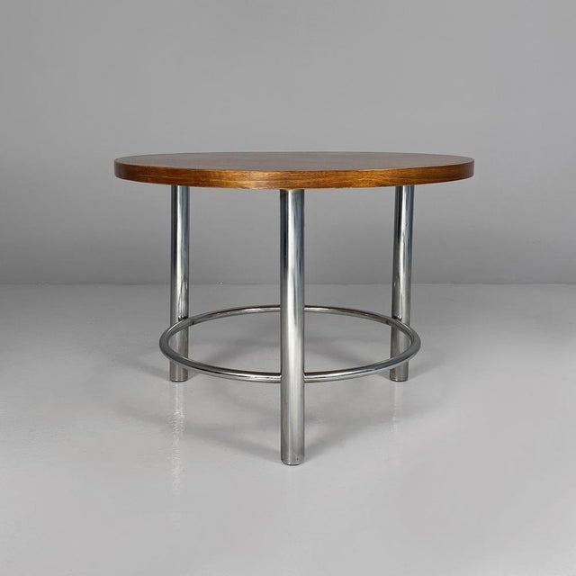 Italian Bauhaus round coffe table in wood and metal, 1930s Coffee table with round wooden top. The frame is made of...