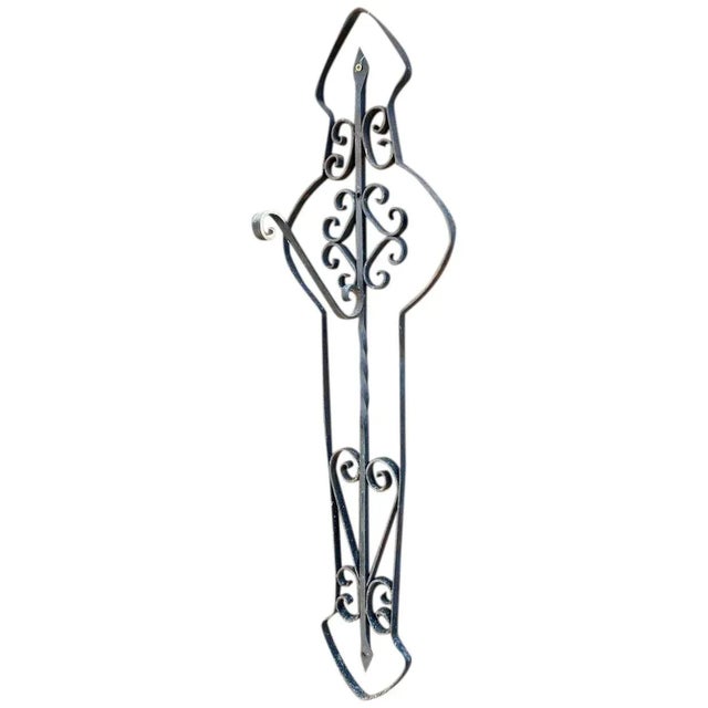 DETAILS A vintage or antique wrought iron wall bracket supporting a scrolled single bracket to hang a lantern or plant....