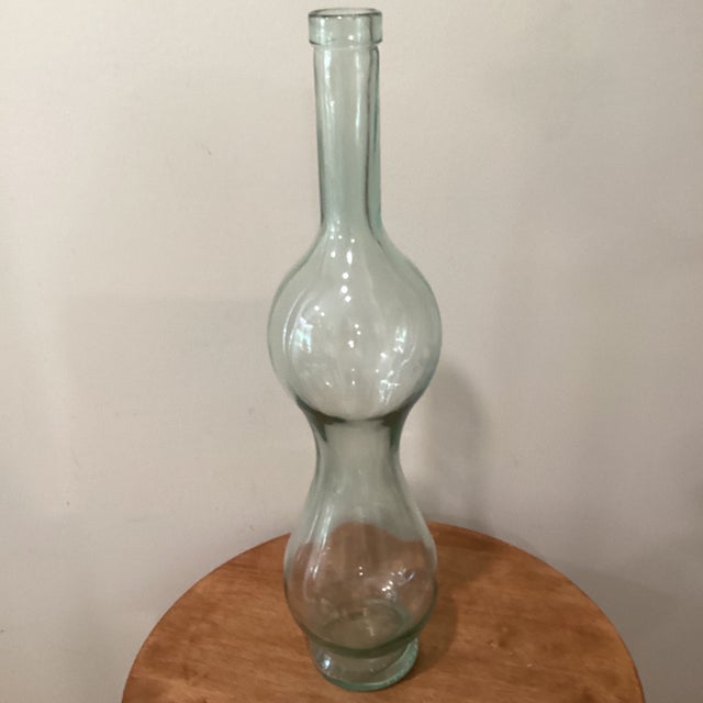 This vintage, large blown art glass green bottle from Italy is a unique piece of mid-century modern decor. Crafted from...
