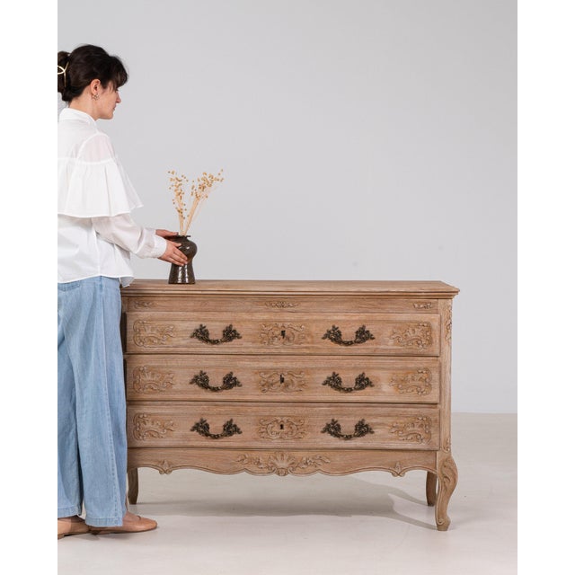 This nightstand makes its impression through natural bleached oak, cabriole legs, single door. The piece dates to 20th...