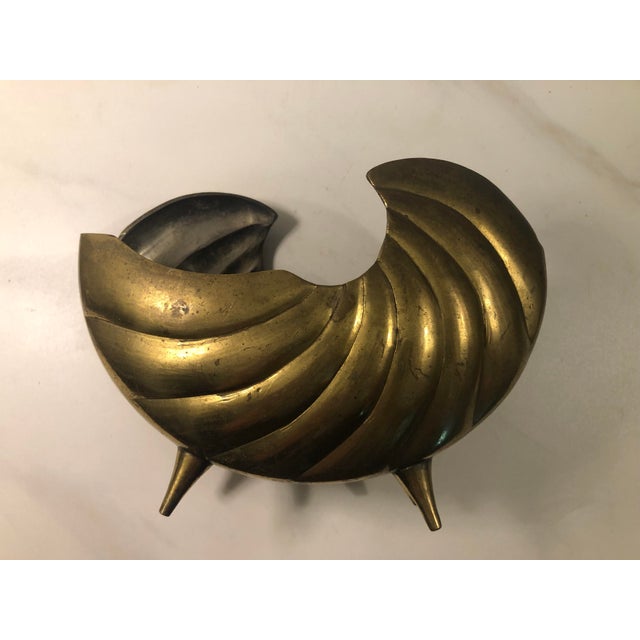 This fabulous 1970s Brass Sea Shell Nautilus Planter that will look amazing on any table in your home. Whether you plant...