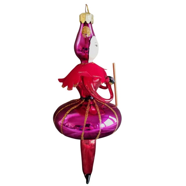 Mouth blown and hand painted hanging Christmas ornament. A hand painted Jester wears a glistening raspberry pink costume...