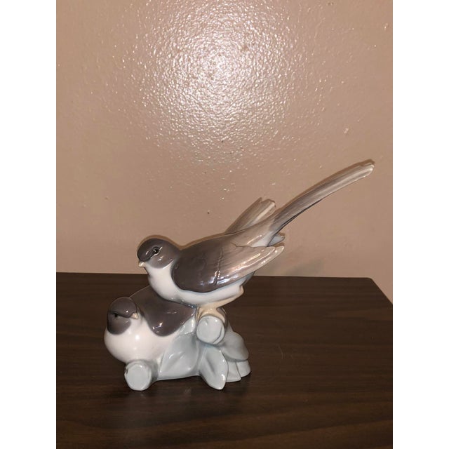 Bring classic European elegance to your space with this vintage Lladró porcelain figurine titled "Birds Two Perched...