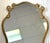 Striking large Hollywood Regency style wall mirror from the late 20th century. The piece is made of wood with an intricate...