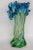 This lovely Vase is made out of hand blown glass, and it is in good condition. This unique vase features a blue to green...