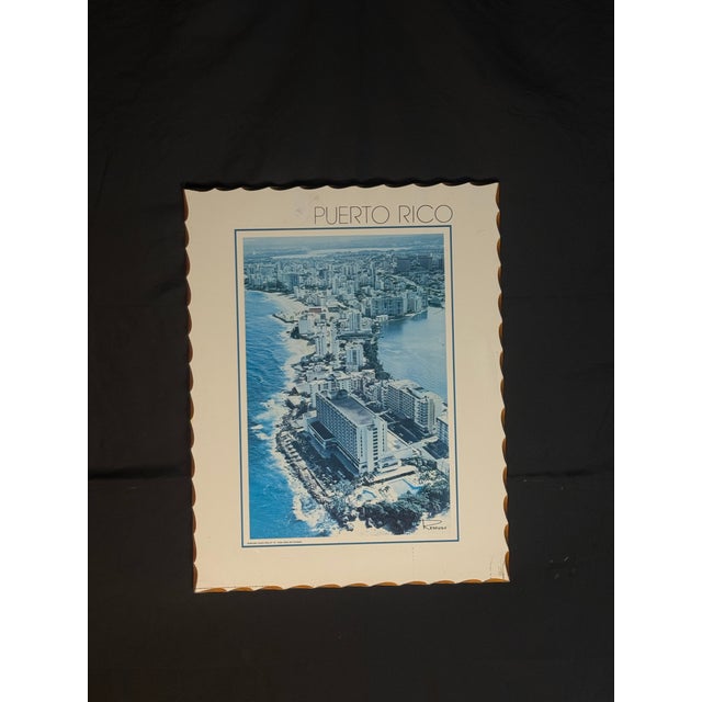 intage-style Puerto Rico wall art featuring a blue-toned aerial coastal city view. The piece shows an oceanfront cityscape...