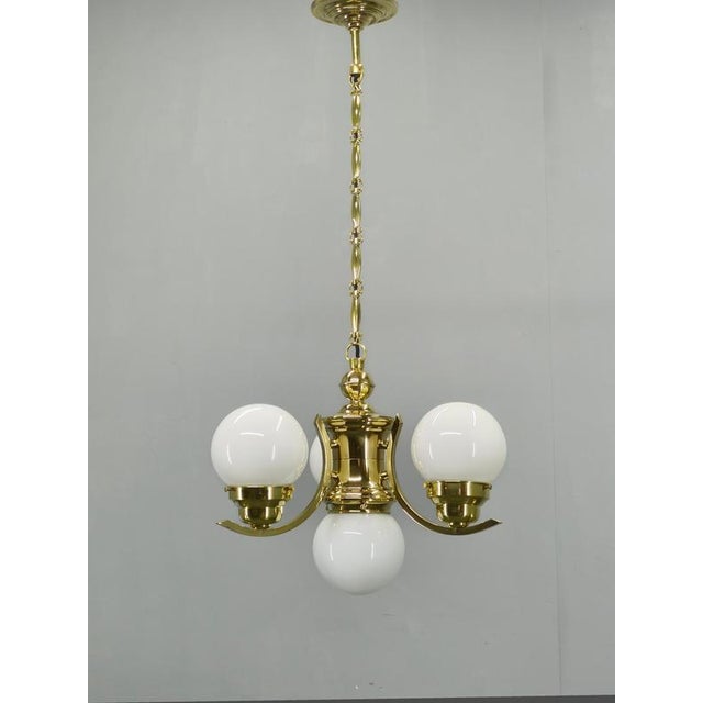 Exceptional Art Deco chandelier produced in Czechoslovakia during the 1930s. This elegant four-light fixture embodies the...