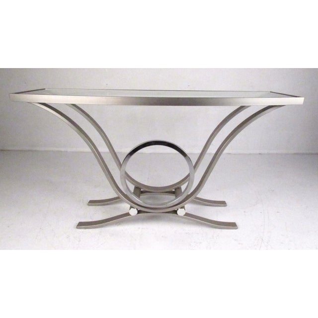 Modern style aluminum console table with demilune shape and beveled glass top.