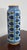 This long porcelain vase, with a white and blue background, has lips and a yellow, etécies base. The pattern squared on...