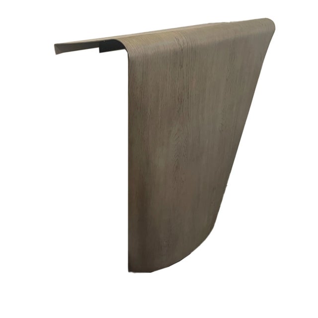 This console is hand-crafted from stainless steel in a white oak. Its organic silhouette, undulating and free-formed,...