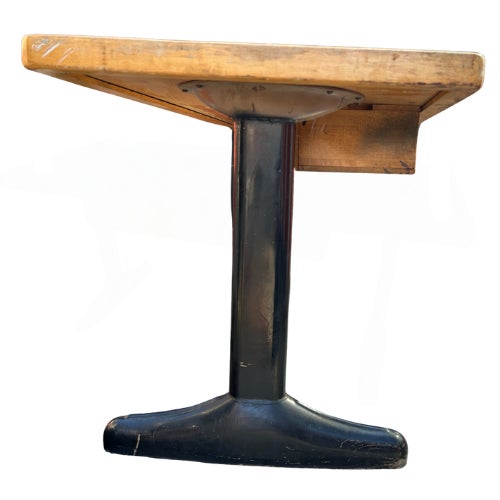 **Description:** Vintage 1950s student desk featuring a maple butcher-block-style writing surface, black steel legs, and...