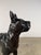 A striking life-size bronze sculpture of a Boxer dog, rendered in a refined and stylized interpretation. This piece leans...
