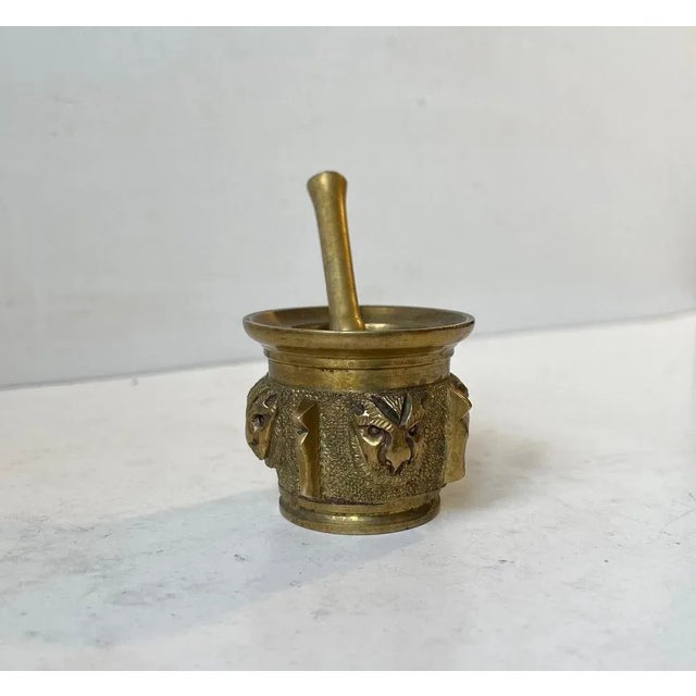 Small heavy apothecary bronze mortar and pestle from 19th century France. The outside of the mortar has been adorned with...