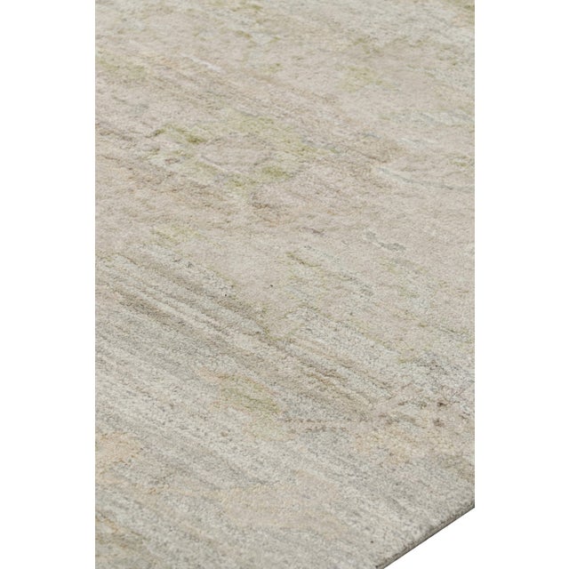 Made with hand-knotted silk and featuring floral patterns in white, green and beige-brown tones, this 9x12 rug from Rug &...