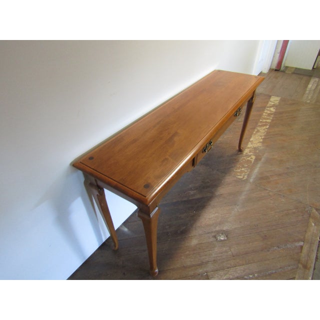 Item 81075: Ethan Allen solid maple console table. Age:1980's. Details: Queen Anne Style with dovetailed drawers....