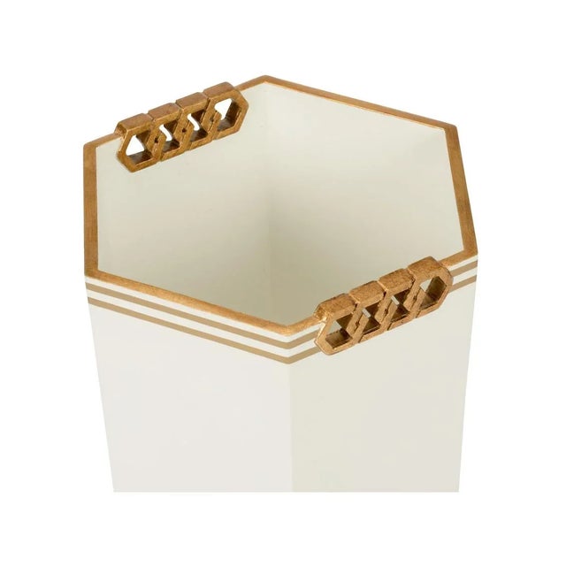 Classic and tailored, this beautiful wastebasket designed by Shayla Copas features gold bands and interlocking gold accent.