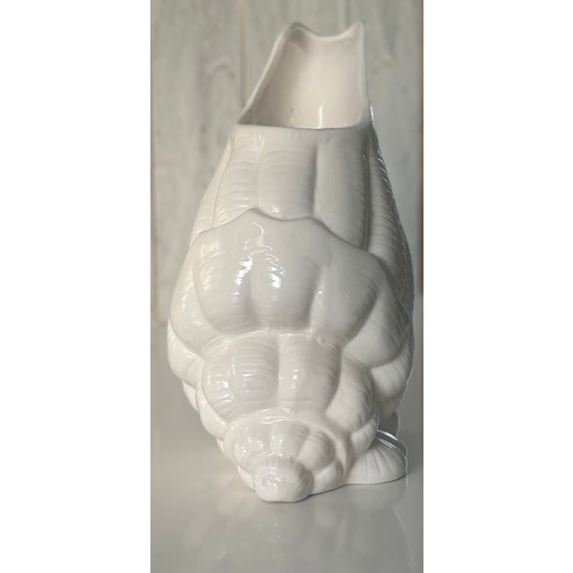 This lovely piece of trompe-l'oiel is an elegant white ceramic vase cleverly disguised as a large conch shell. The...